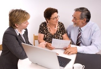 A couple going over paperwork with a profeccional