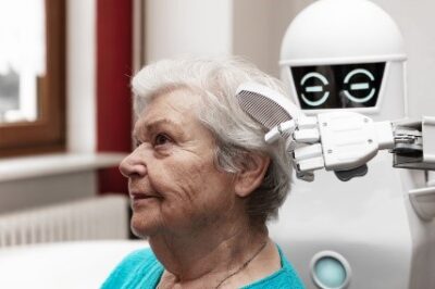 WIll-Robotics-be-and-AI-be-the-future-of-elder-care? Image-of-robot-brushing-woman's-hair Elder-care