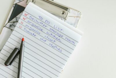 notepad on a table that has a to-do list written on it
