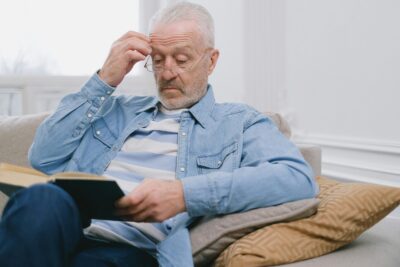 Older man reading on the sofa